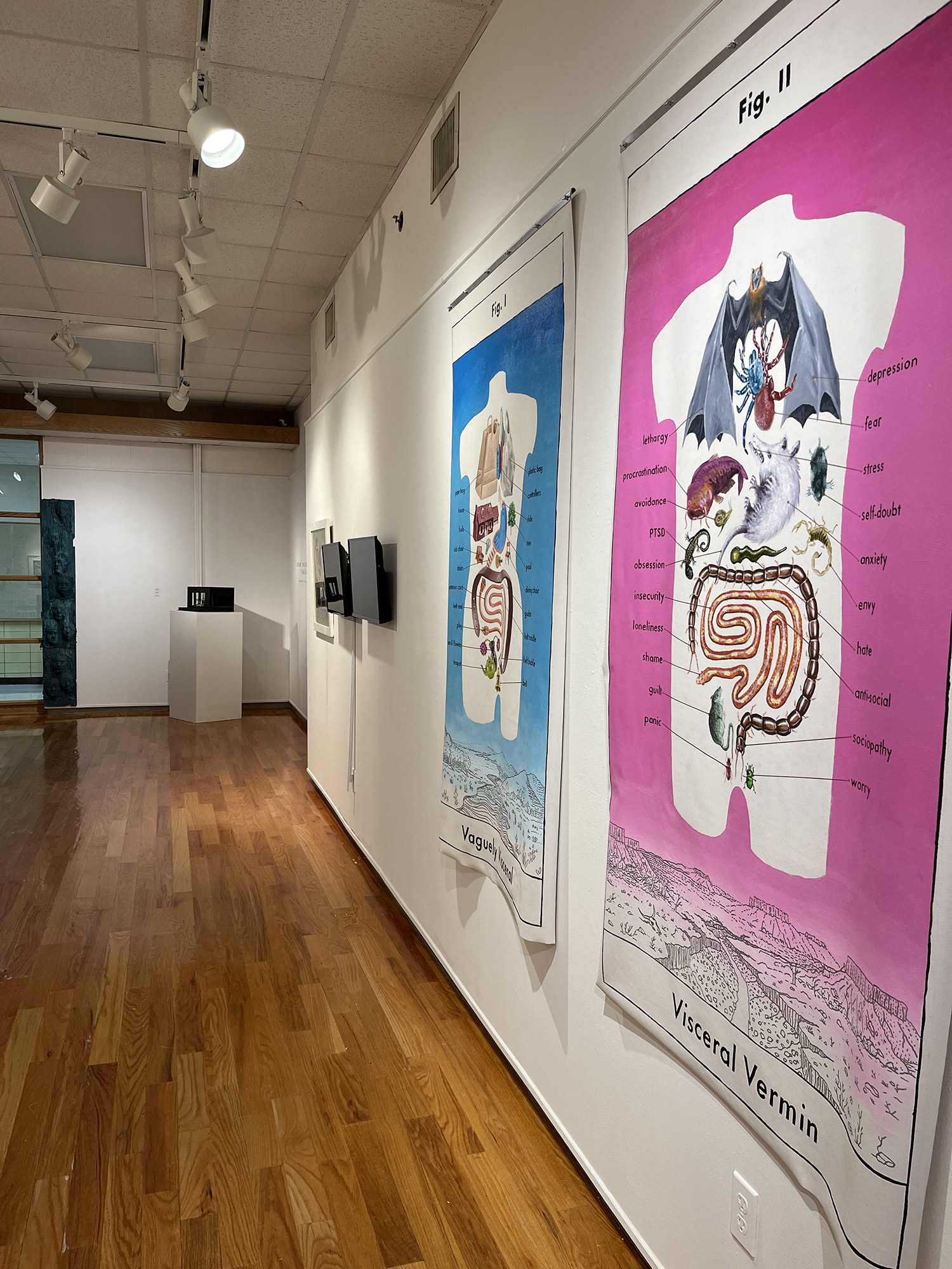 gallery with a pink painting on the far right and a blue painting to the left